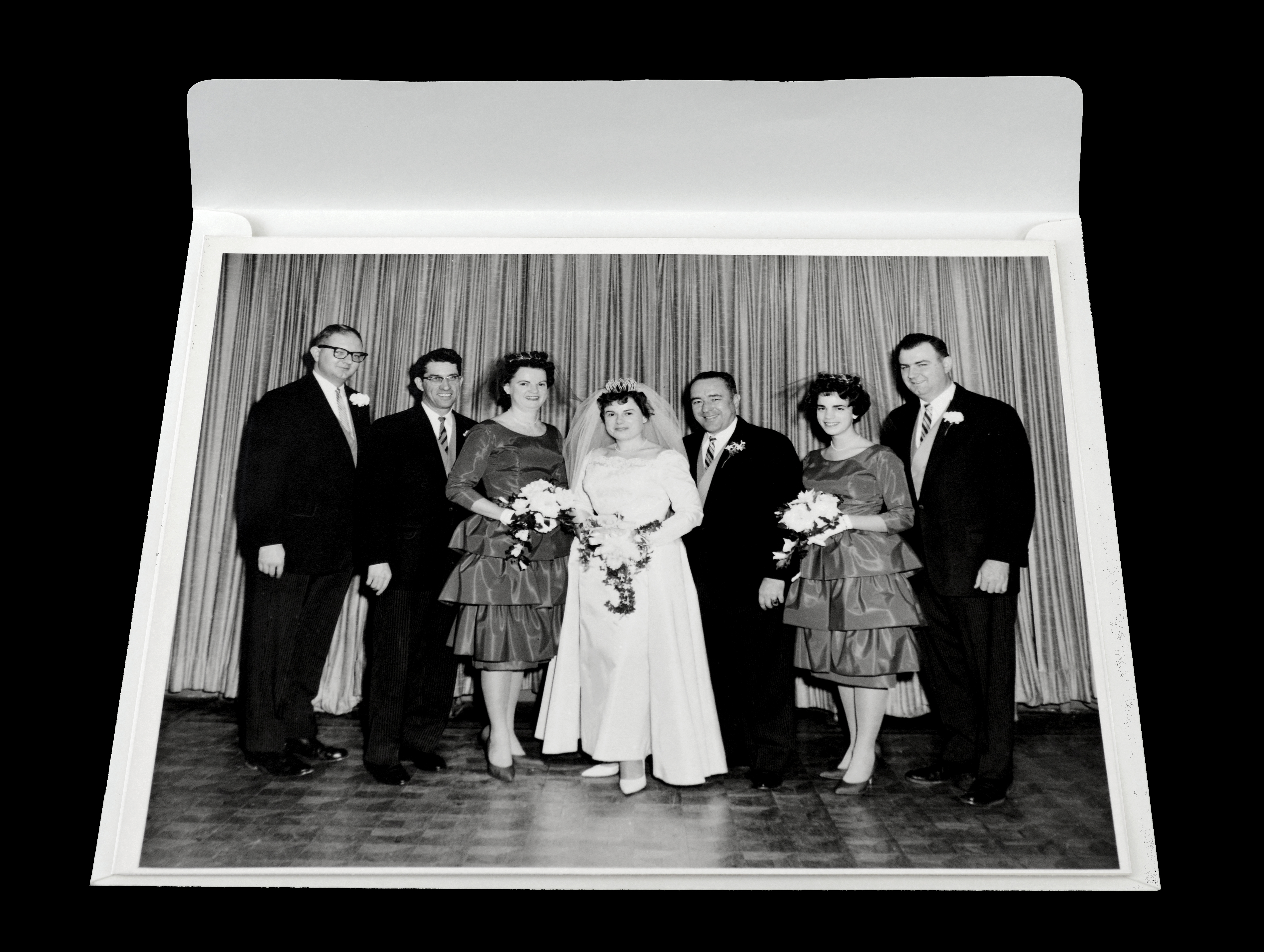 Vintage black & white photo of a wedding party atop acid-free archival buffered envelope with flap on long edge, no adhesive on flap