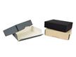 Three drop front archival storage boxes made of acid-free board in tan, gray, and black, stacked on top of each other. thumbnail